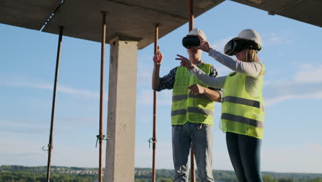 Waist-up-portrait-of-two-modern-construction-workers-using-VR-gear-to-visualize-projects-on-site-copy-space